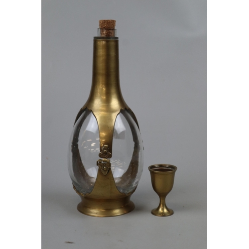 167 - Interesting brass and glass decanter with cup acting as lid