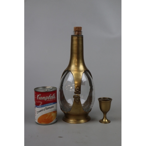 167 - Interesting brass and glass decanter with cup acting as lid