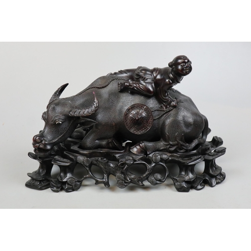 225 - Finely carved figure of man on bull on ornate carved stand