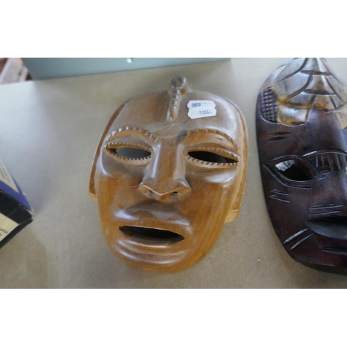 329 - 3 tribal masks together with 2 carved animals