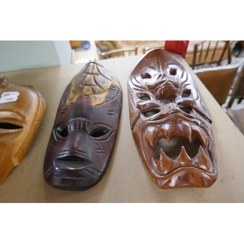 329 - 3 tribal masks together with 2 carved animals