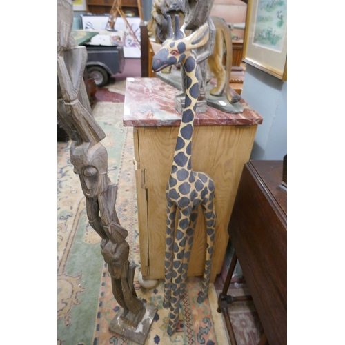 482 - 2 tribal carvings together with a carved giraffe