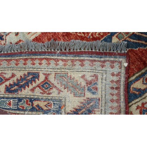 625 - Red and blue patterned rug - Approx size: 176cm x 127cm