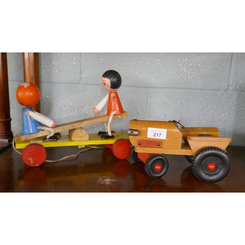 217 - 1950's pull along toy together with a tractor