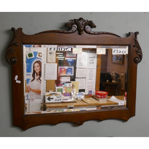 395 - Carved wooden framed, beveled glass mirror