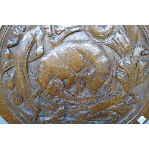 343 - Large circular carved oak wall plaque of a dog