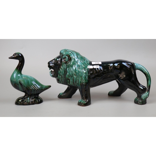 176 - Large glazed ceramic lion and duck figure - Approx height 22cm Length of lion approx 43cm