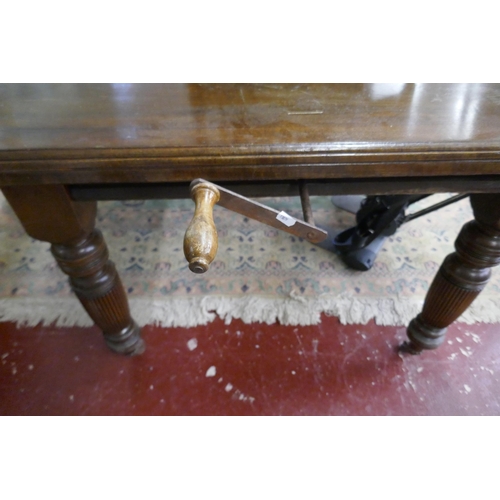 334 - Edwardian wind out table on casters with leaf and winder