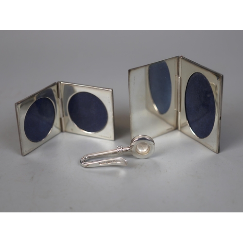 151 - 2 hallmarked silver miniature folding photo frames together with a hallmarked silver napkin clip