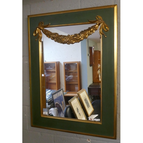 473 - Gilt framed mirror adorned with gilt swag