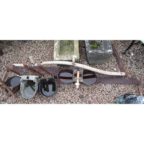 564 - Collection of feeding troughs together with a scythe and a 2 handed saw