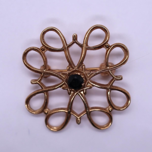 67 - 9ct gold brooch set with a sapphire