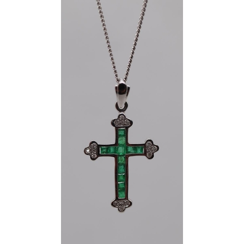 68 - 18ct white gold Emerald and diamond crucifix on 18ct white gold chain together with a silver pendant... 