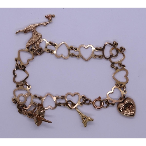 77 - 9ct gold charm bracelet