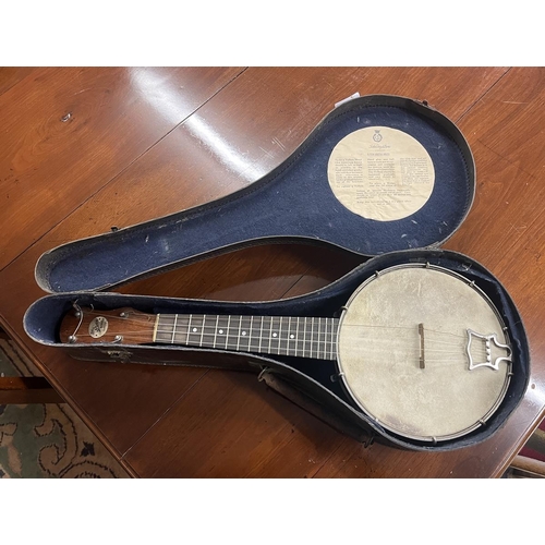 390 - Banjo in case by John Grey and Sons of London