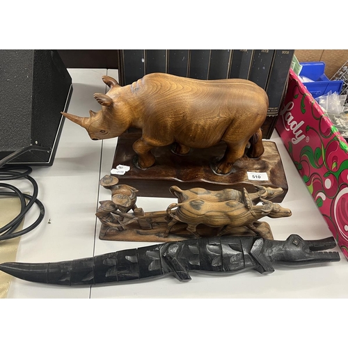 510 - Carved wooden animals to include large rhino