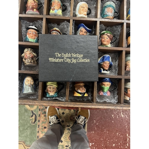 499 - 25 miniature Toby jugs in display case