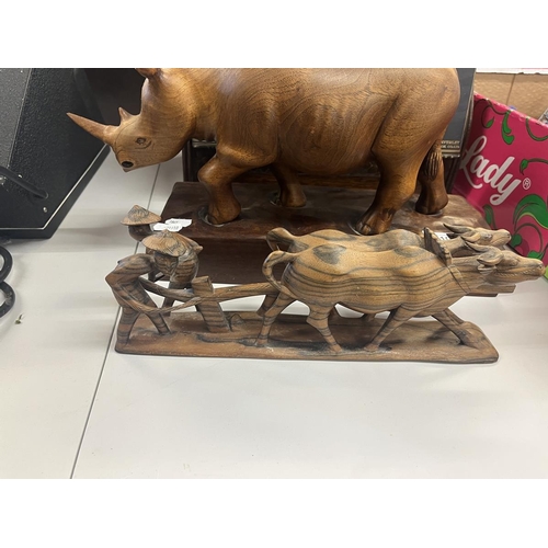 510 - Carved wooden animals to include large rhino