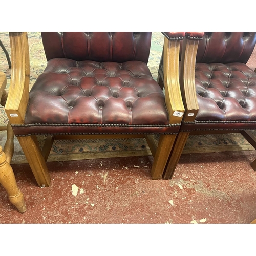 581 - Pair of ox blood leather armchairs