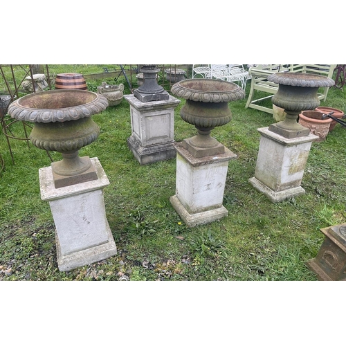 114 - Set of 3 cast iron pedestal planters on stone plinths