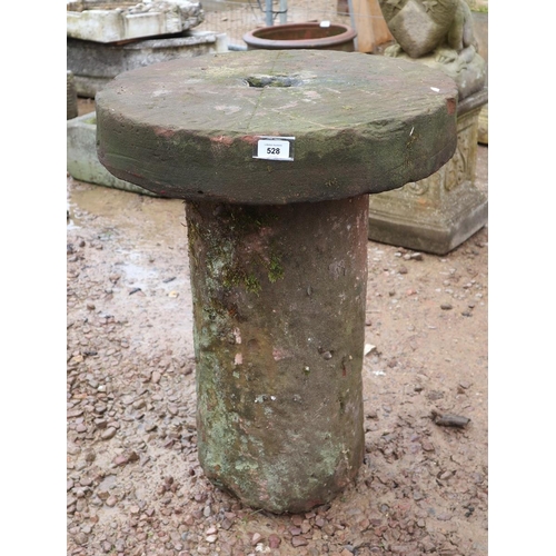 528 - Old mill wheel on stone base