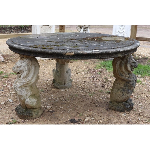 573 - Large stone circular lion themed garden table - Approx size: Diameter: 136cm H: 73cm