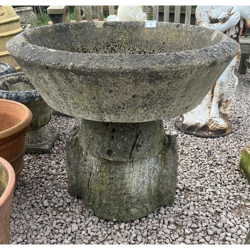 63 - Large round stone planter on limestone base