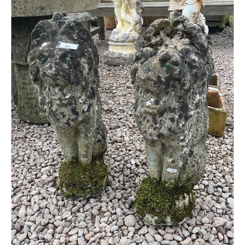 67 - Pair of small sitting stone lions