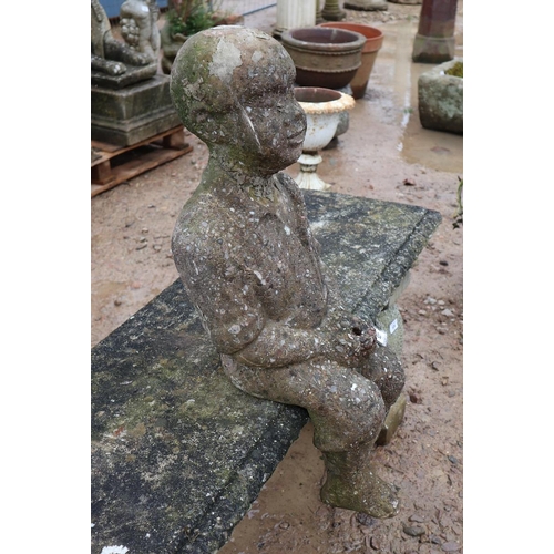 527 - Stone seated man figure