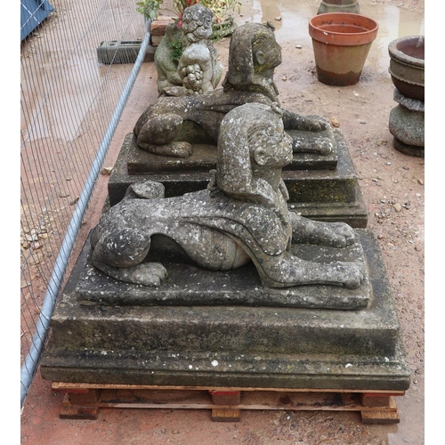 532 - Pair of recon stone Sphinx's on plinths - Approx height: 70cm