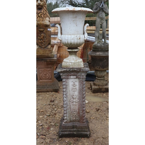 568 - Small pair of cast iron pedestal urns on stone bases