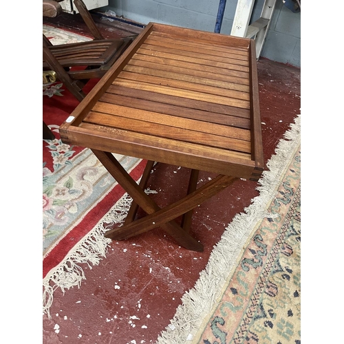 688 - 2 teak chairs together with a teak campaign style table