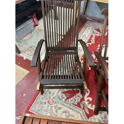 688 - 2 teak chairs together with a teak campaign style table