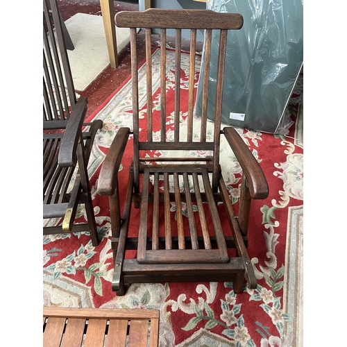 688 - 2 teak chairs together with a teak campaign style table