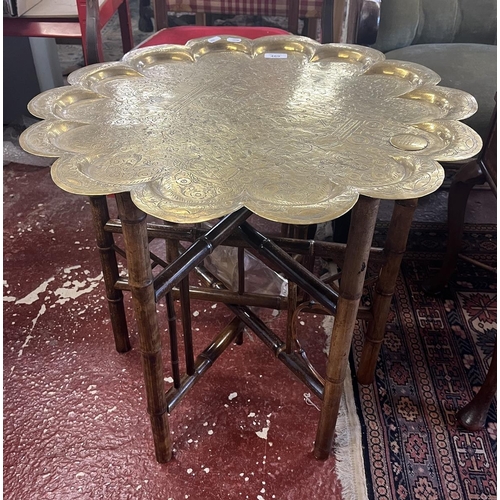 469 - Folding brass toped table with provenance