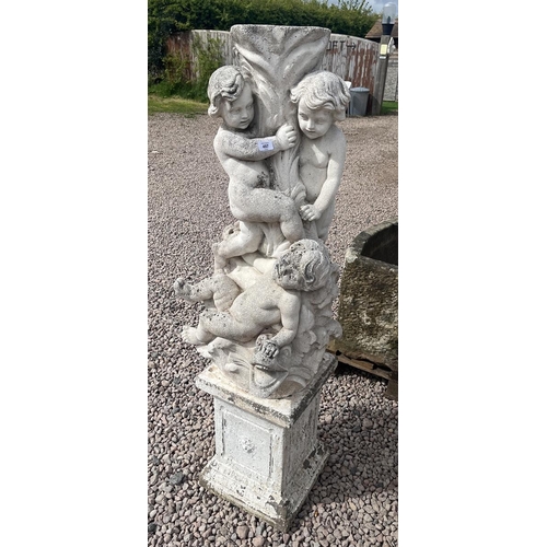 497 - Stone pedestal adorned with cherubs and dolphins on stone base - Approx height: 138cm