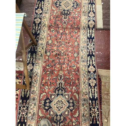 304 - Large red patterned runner - Approx size: 620cm x 78cm