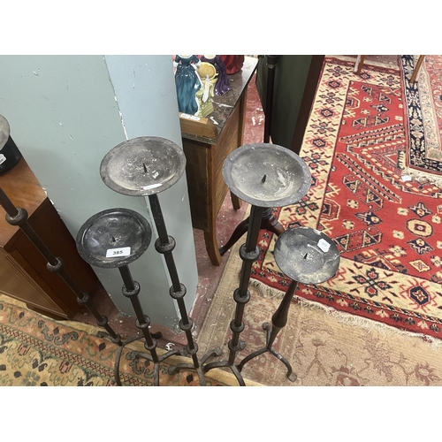 385 - Set of 4 floor standing candle holders together with another