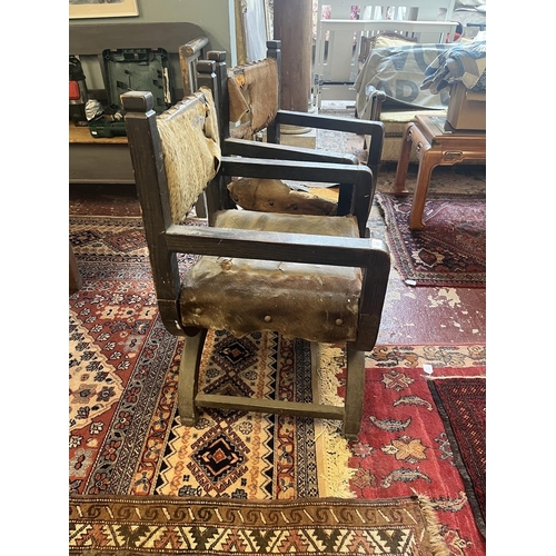 437 - Pair of X framed chairs upholstered with animal hides