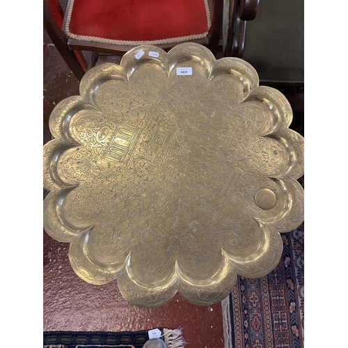 469 - Folding brass toped table with provenance