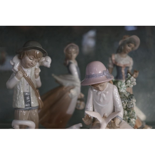 154 - Collection of figurines to include Nao, Lladro etc