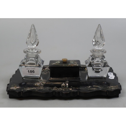 186 - Oriental Paper Mache desk tidy inlaid with mother of pearl together with 2 cut glass inkwells