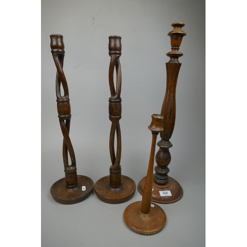 254 - Pair of tall wooden candlesticks together with 2 others