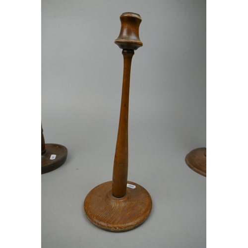 254 - Pair of tall wooden candlesticks together with 2 others