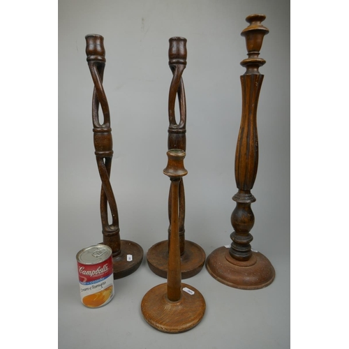 254 - Pair of tall wooden candlesticks together with 2 others