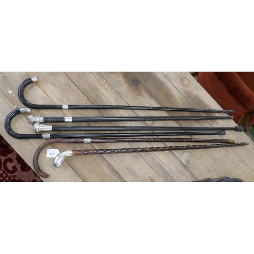 275 - 4 ebonized walking canes with hallmarked silver collar, handle and tips together with 2 possibly Bla... 