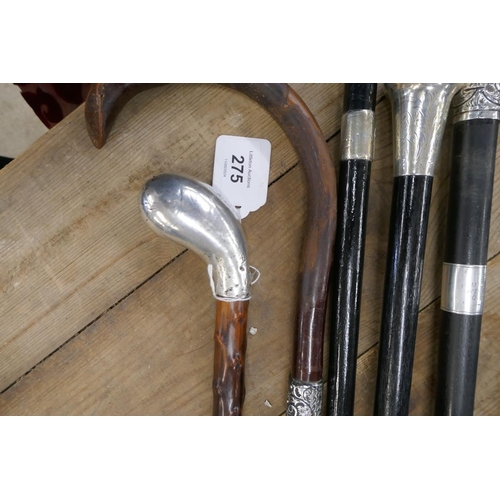 275 - 4 ebonized walking canes with hallmarked silver collar, handle and tips together with 2 possibly Bla... 