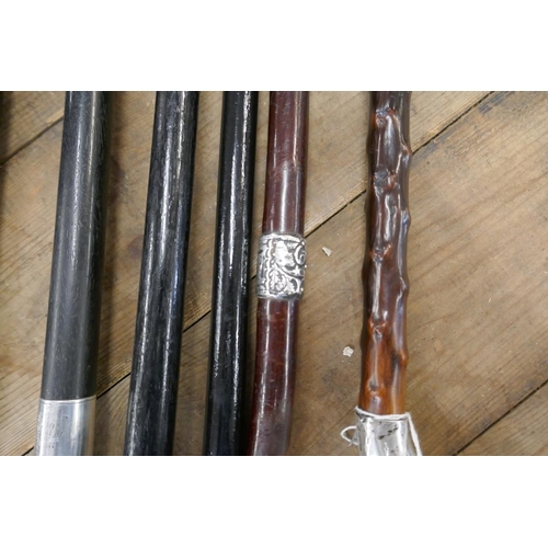 275 - 4 ebonized walking canes with hallmarked silver collar, handle and tips together with 2 possibly Bla... 