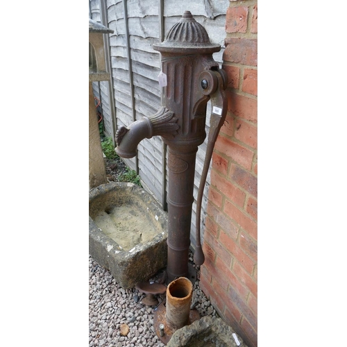 505 - Cast iron pump together with a small metal bird bath