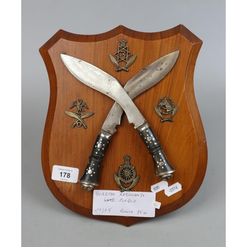 178 - Gurkha Army Plaque with several Regimental Badges and crossed Kukhris